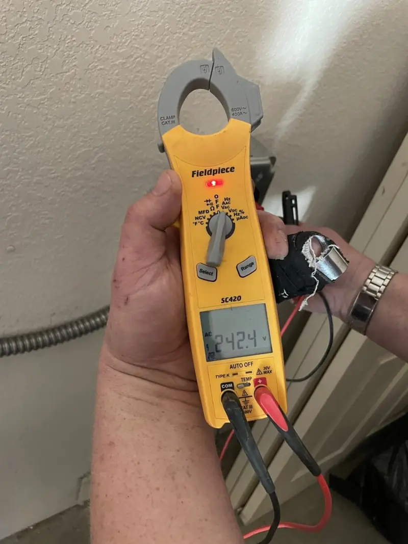 Voltage testing with clamp meter during Outlet Installation in Madera